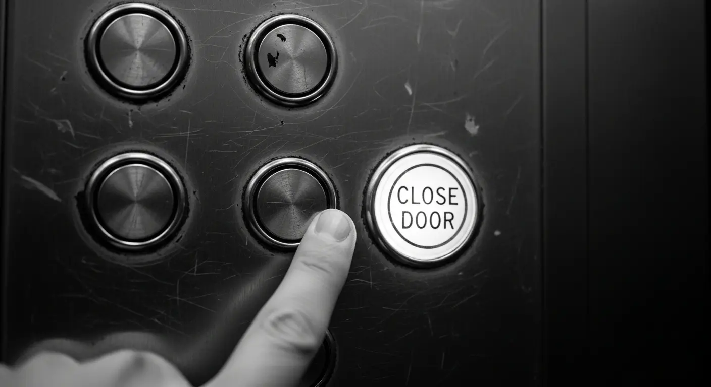 A close-up shot of a worn elevator button panel, with the 'close door' button illuminated and a finger about to press it.